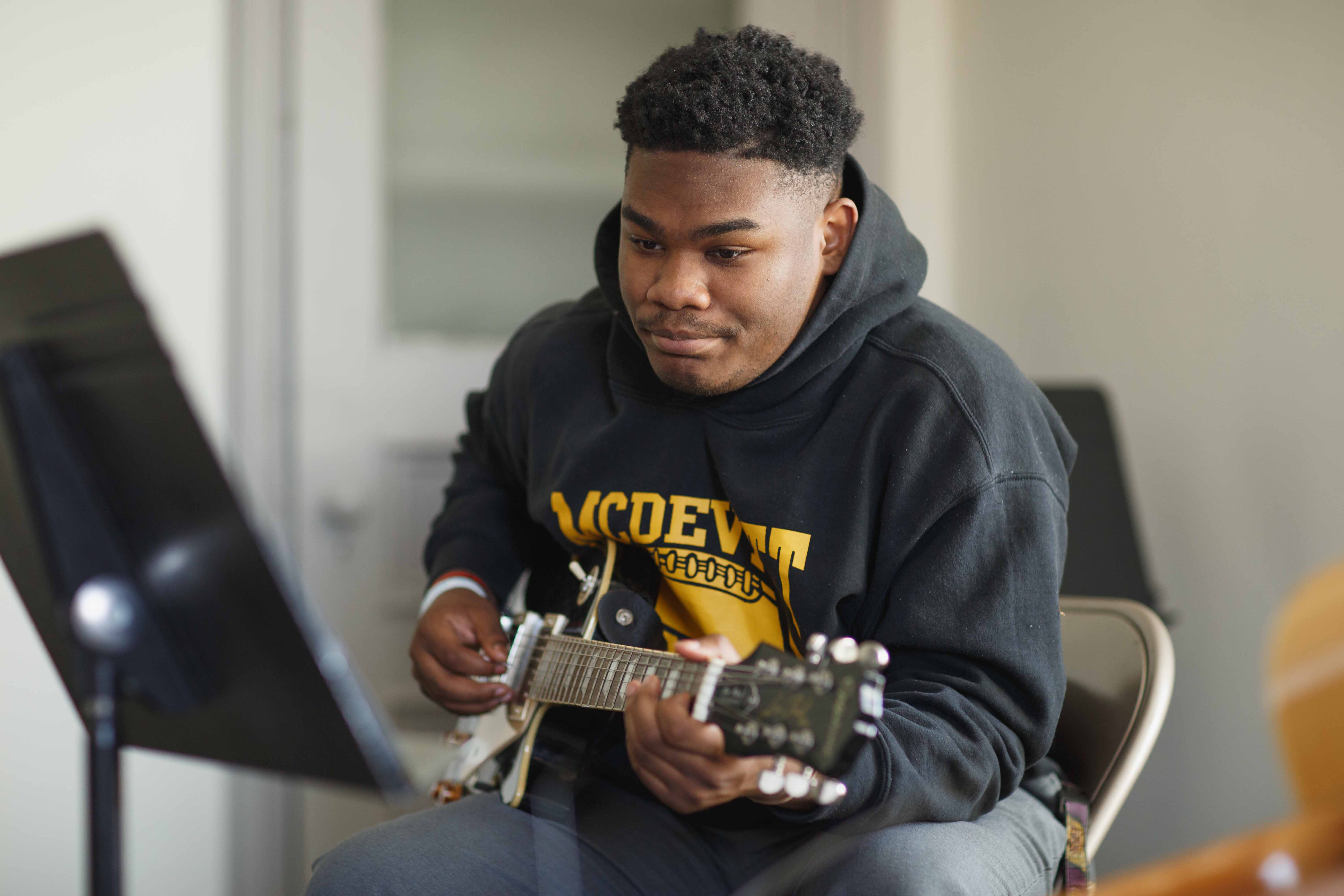 Student plays the electric guitar