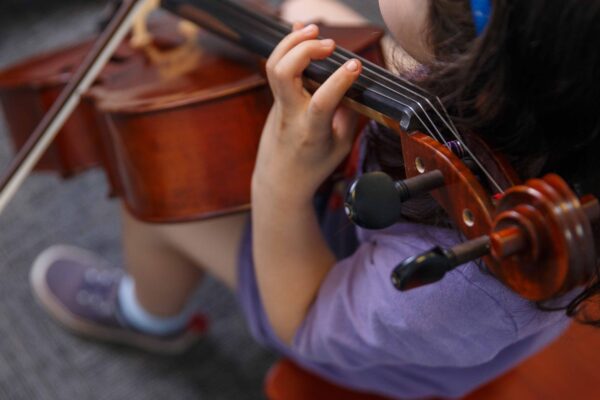 A young cello student rehearses at the Germantown Branch