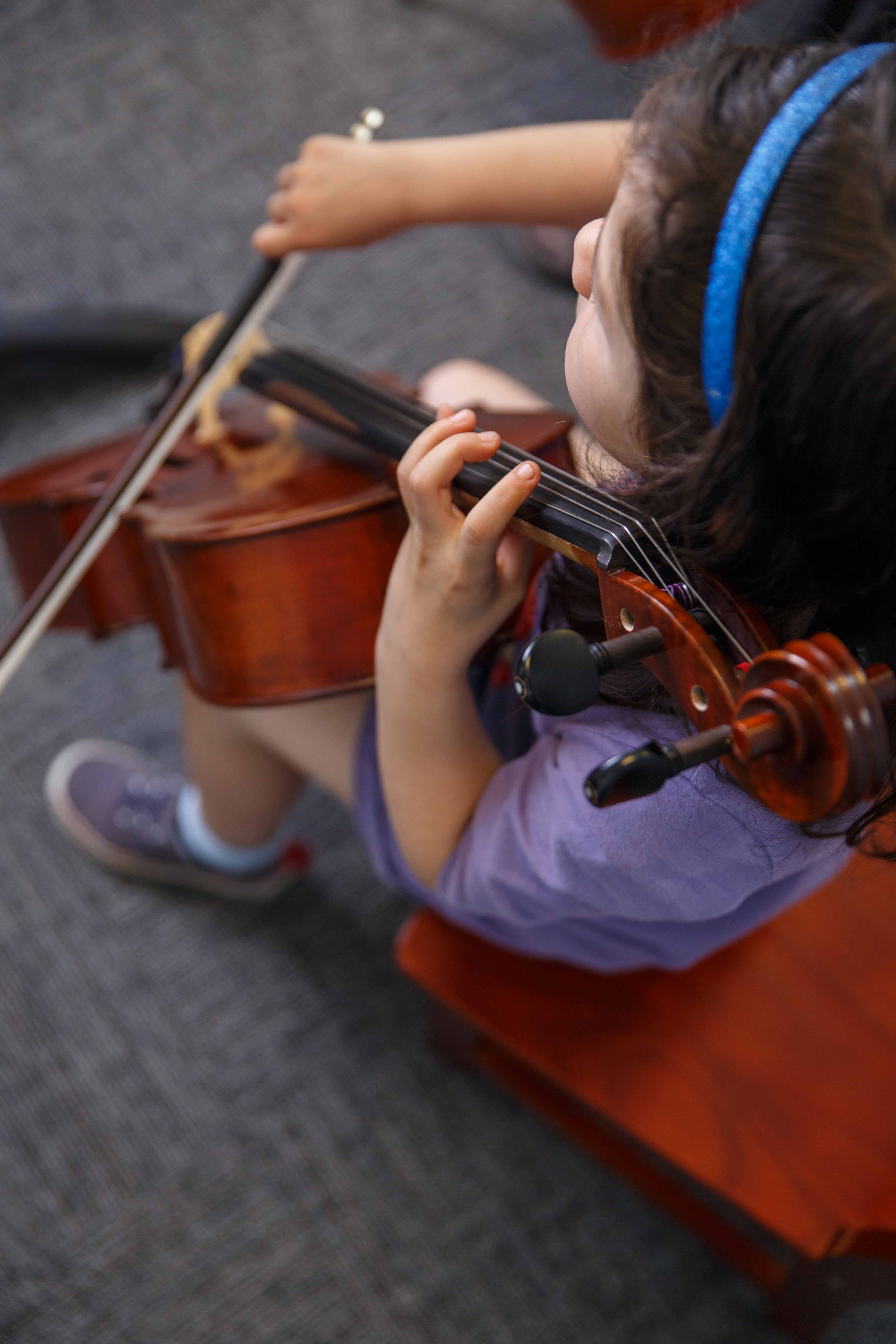 A young cello student rehearses at the Germantown Branch
