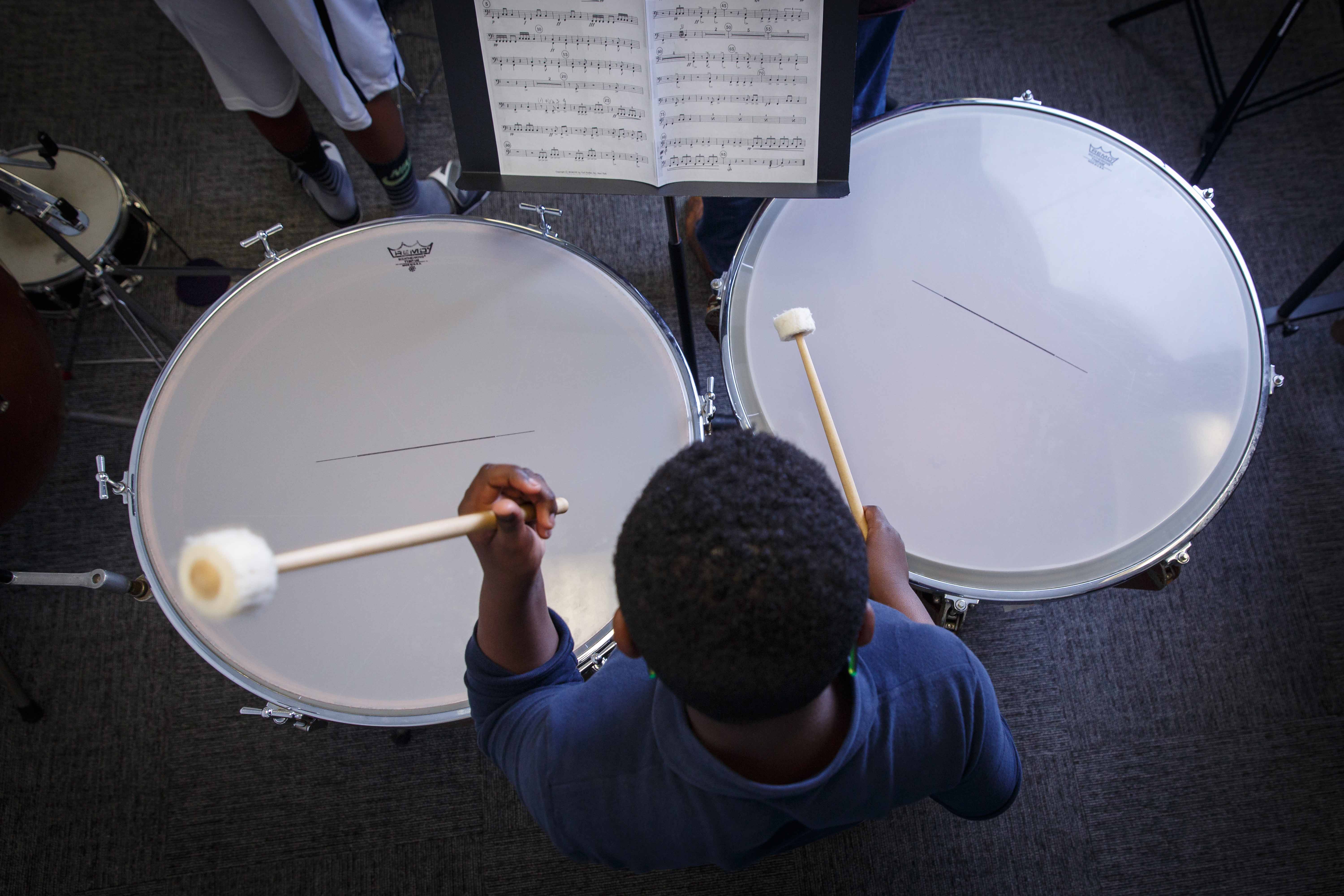 A student plays the drums at the Germantown Branch