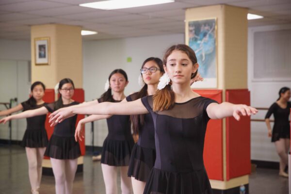 Settlement dancers prepare for an upcoming performance