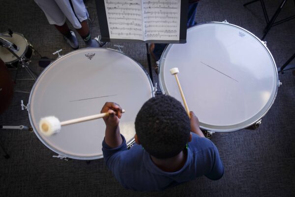 Settlement student playing timpani