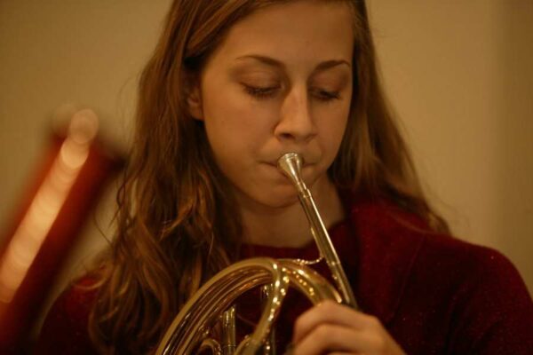 Settlement student plays french horn