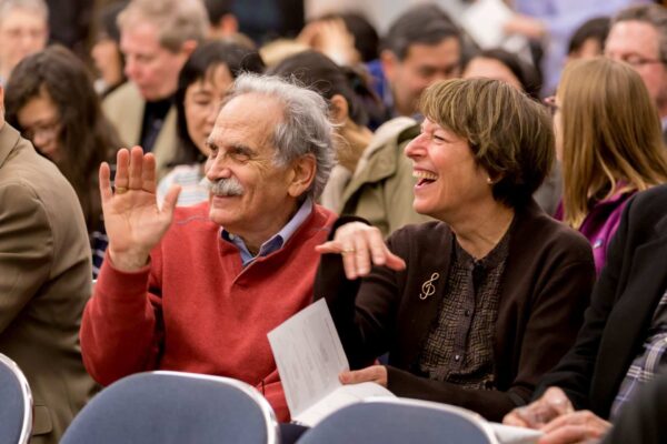 Happy audience members at a Settlement performance