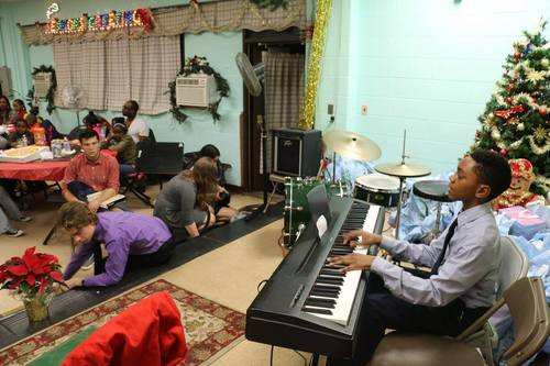 Settlement jazz students perform at a community holiday event