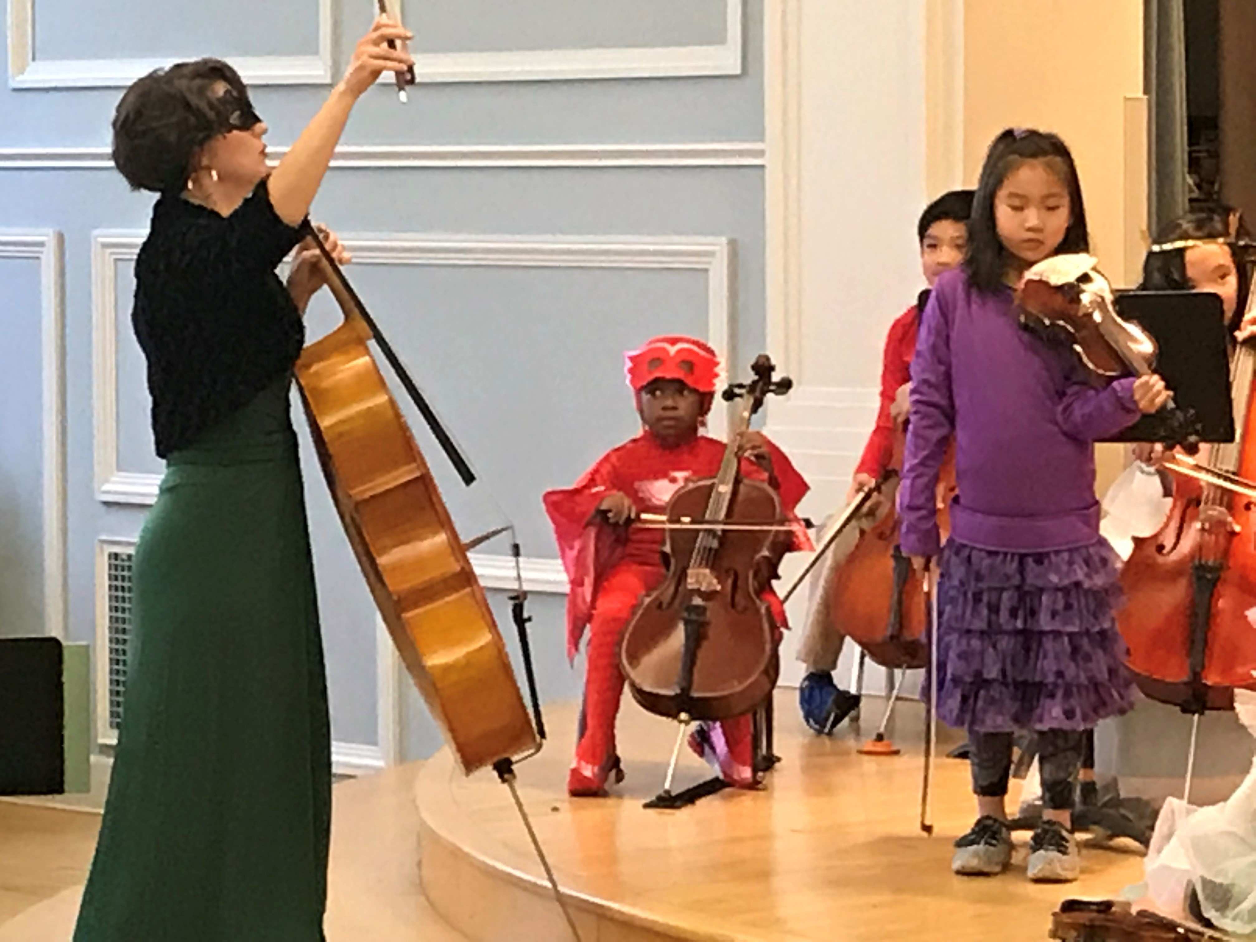 Young students perform during a Halloween-themed performance.