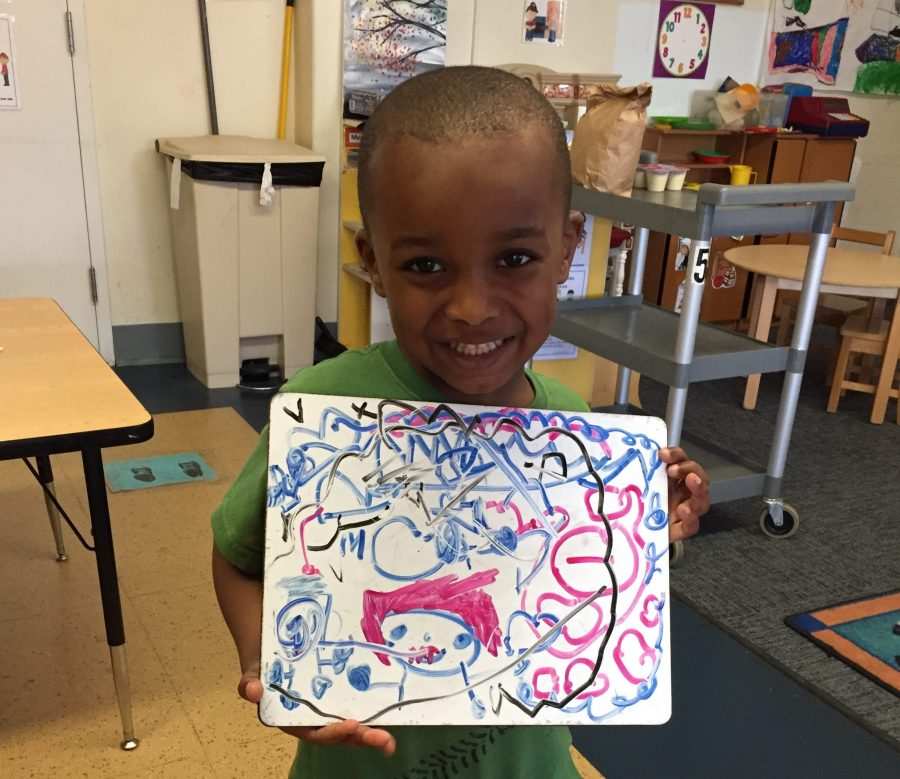 A Kaleidoscope student shows off his artwork.