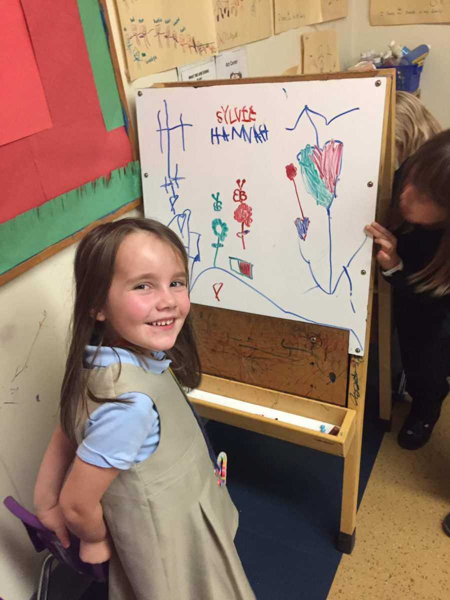 A Kaleidoscope student shows off her artwork.
