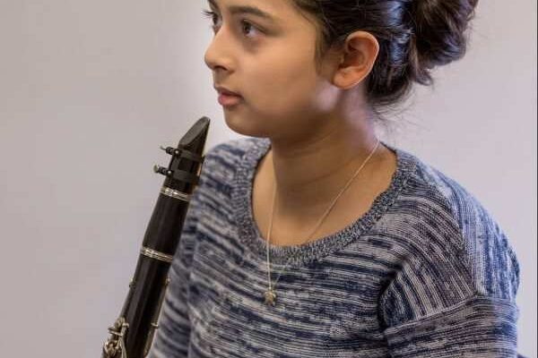 A Settlement student rehearses clarinet