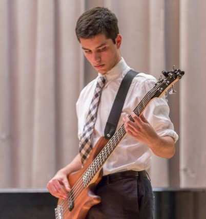 Settlement student plays the electric bass